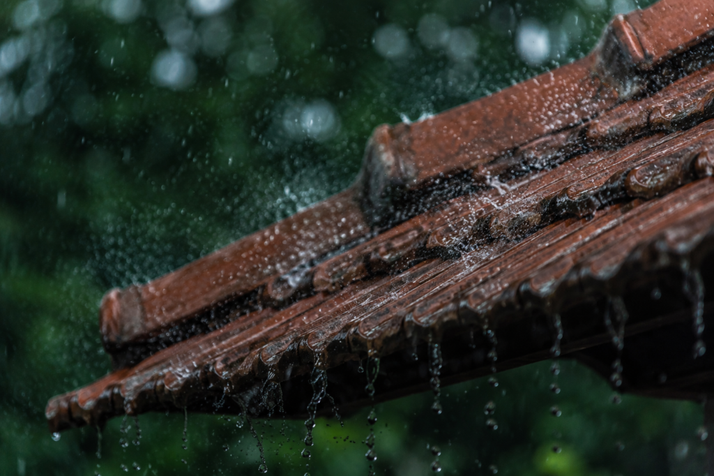 Monsoon rain on Kerala clay tile roof — why roofing material choice matters